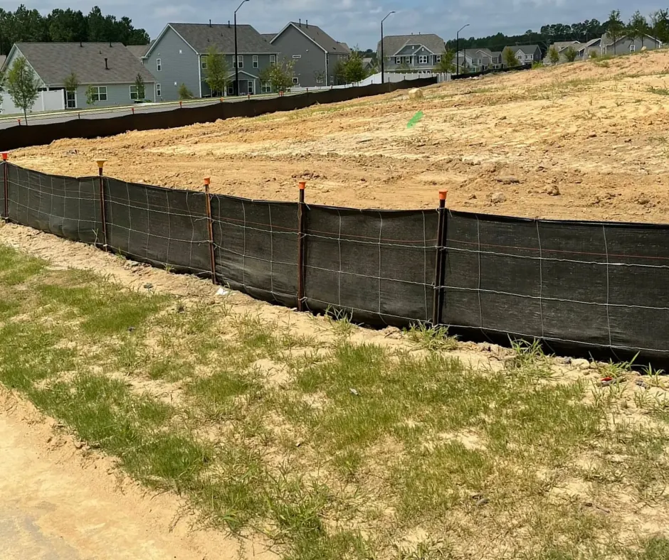 Silt fence with caps along a boundary