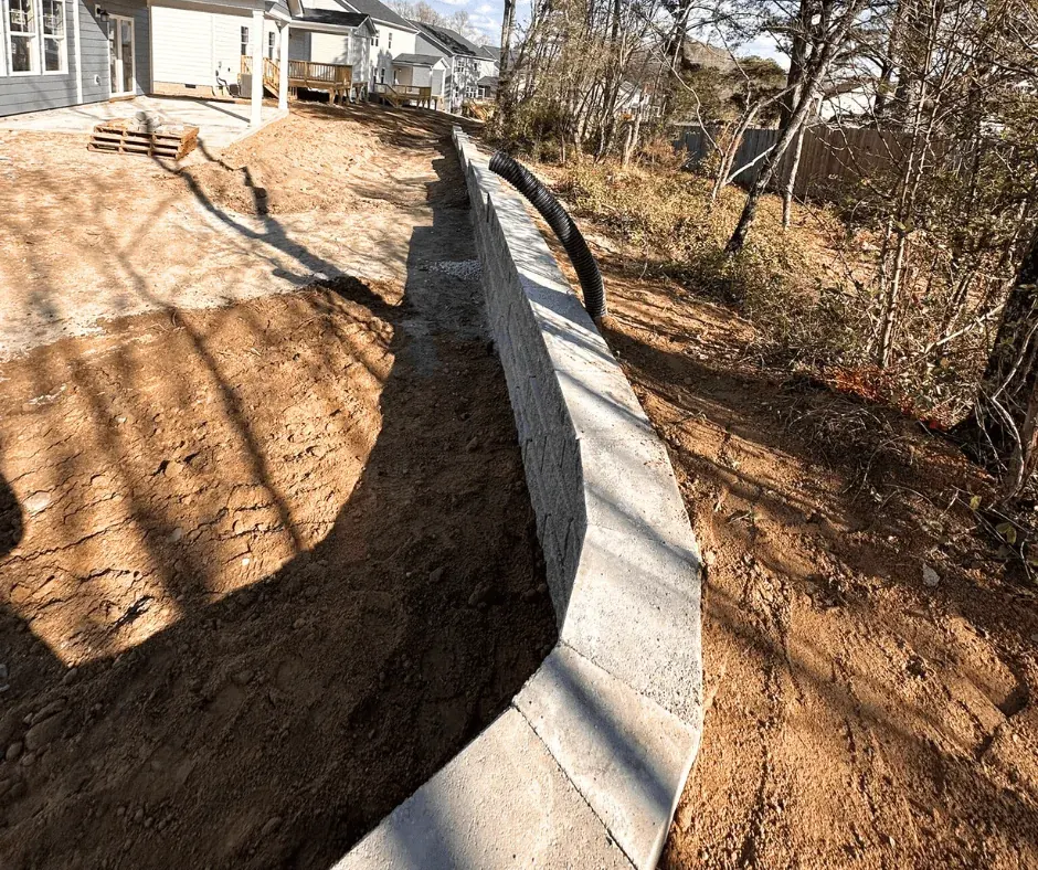 Finished retaining wall stabilizing the slope behind a home