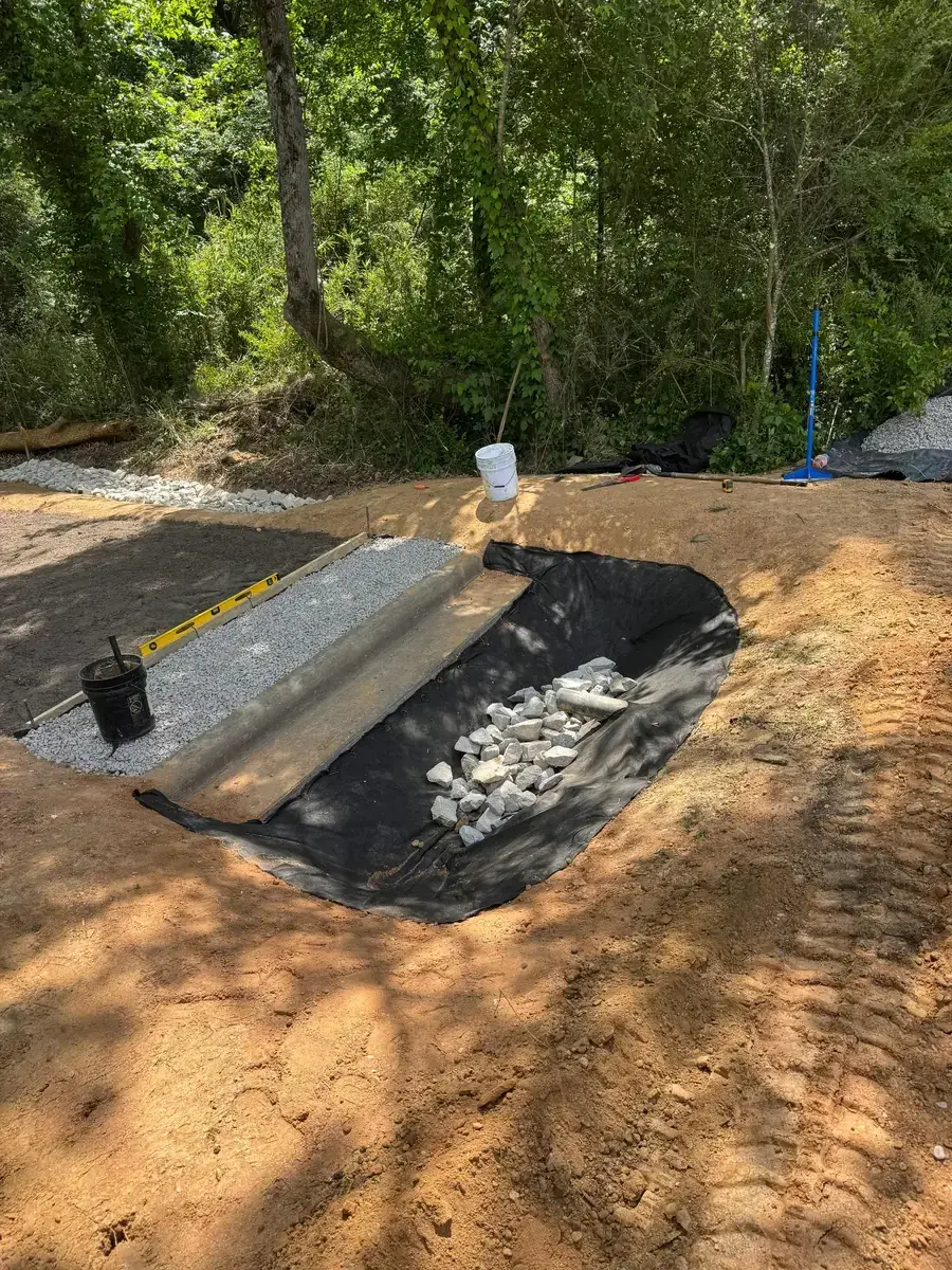 Excavated site before installing a rip-rap dissipator pad