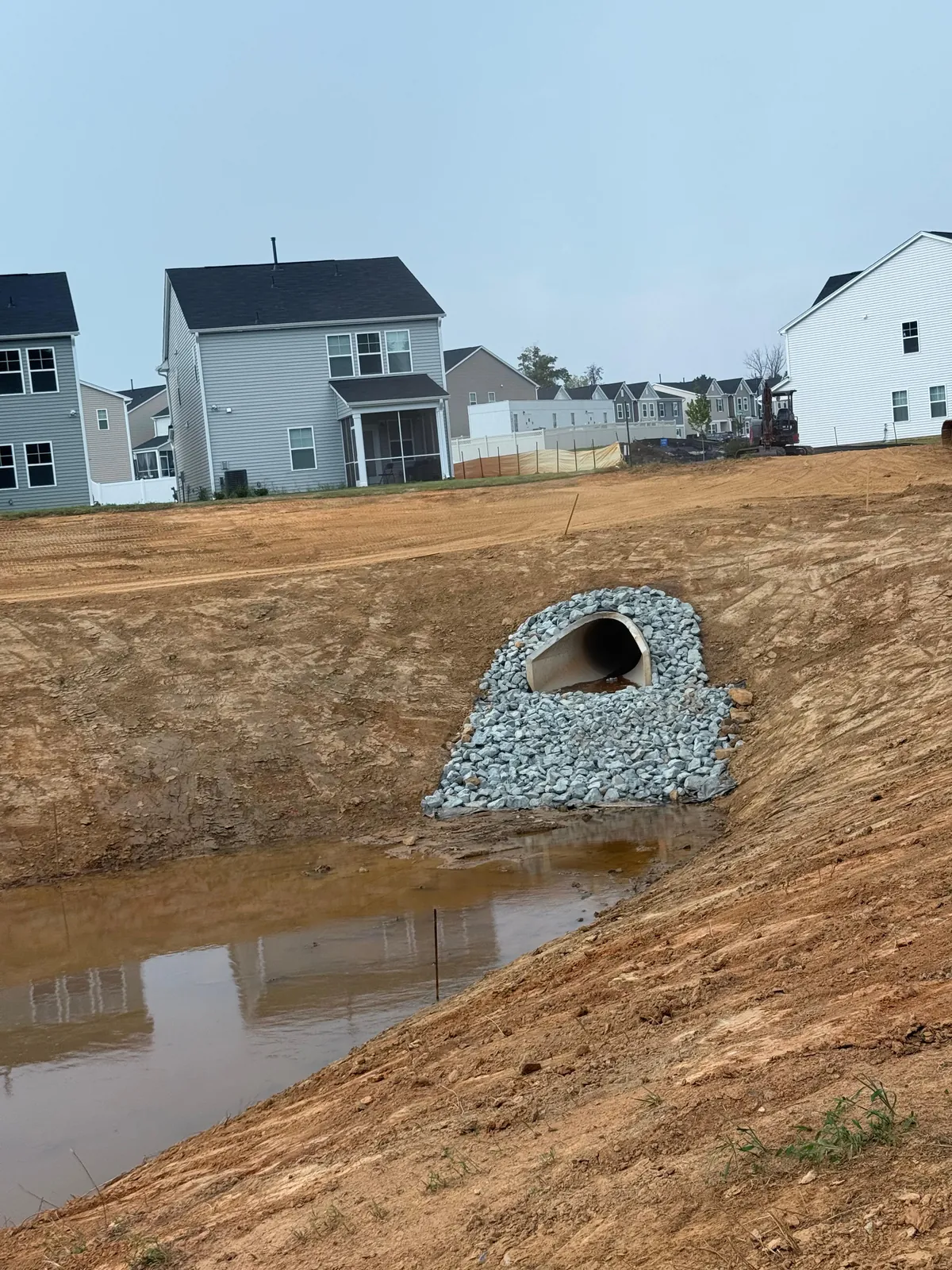 Culvert pipe outlet with a stone rip-rap dissipator apron