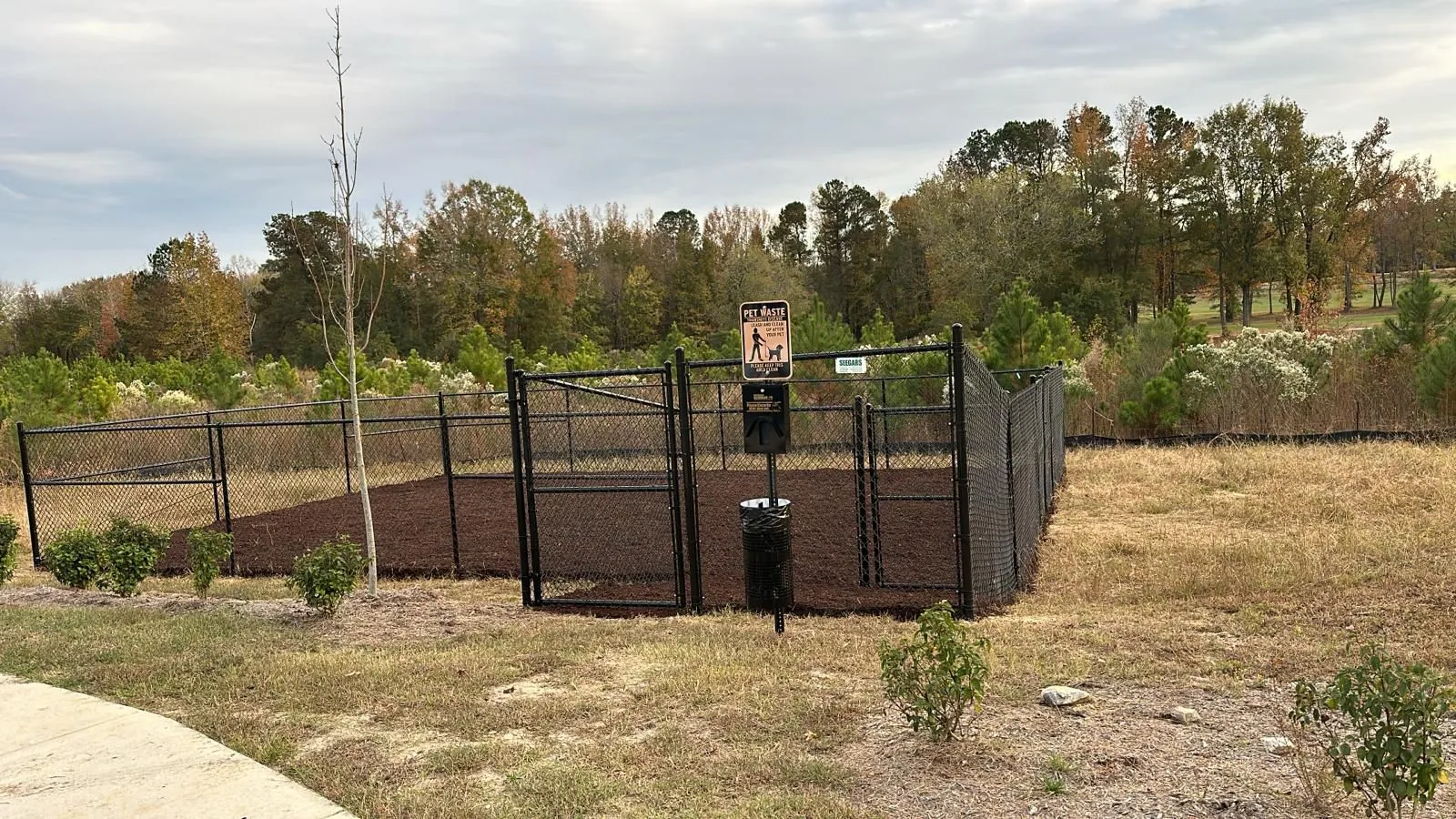 Freshly mulched planting bed at a community entrance