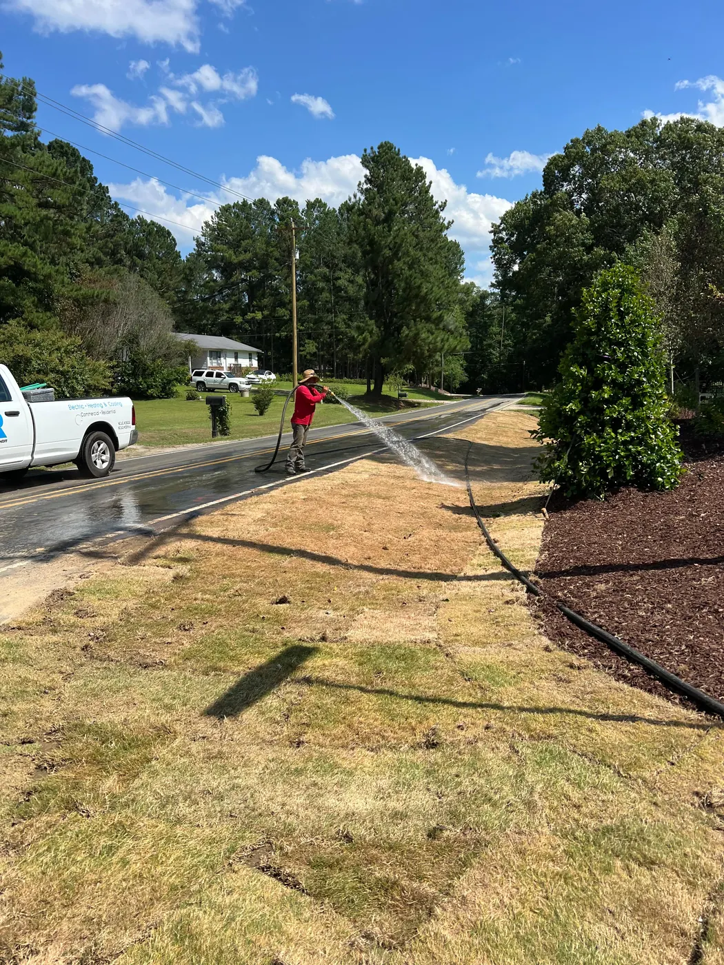 Crew watering freshly installed sod
