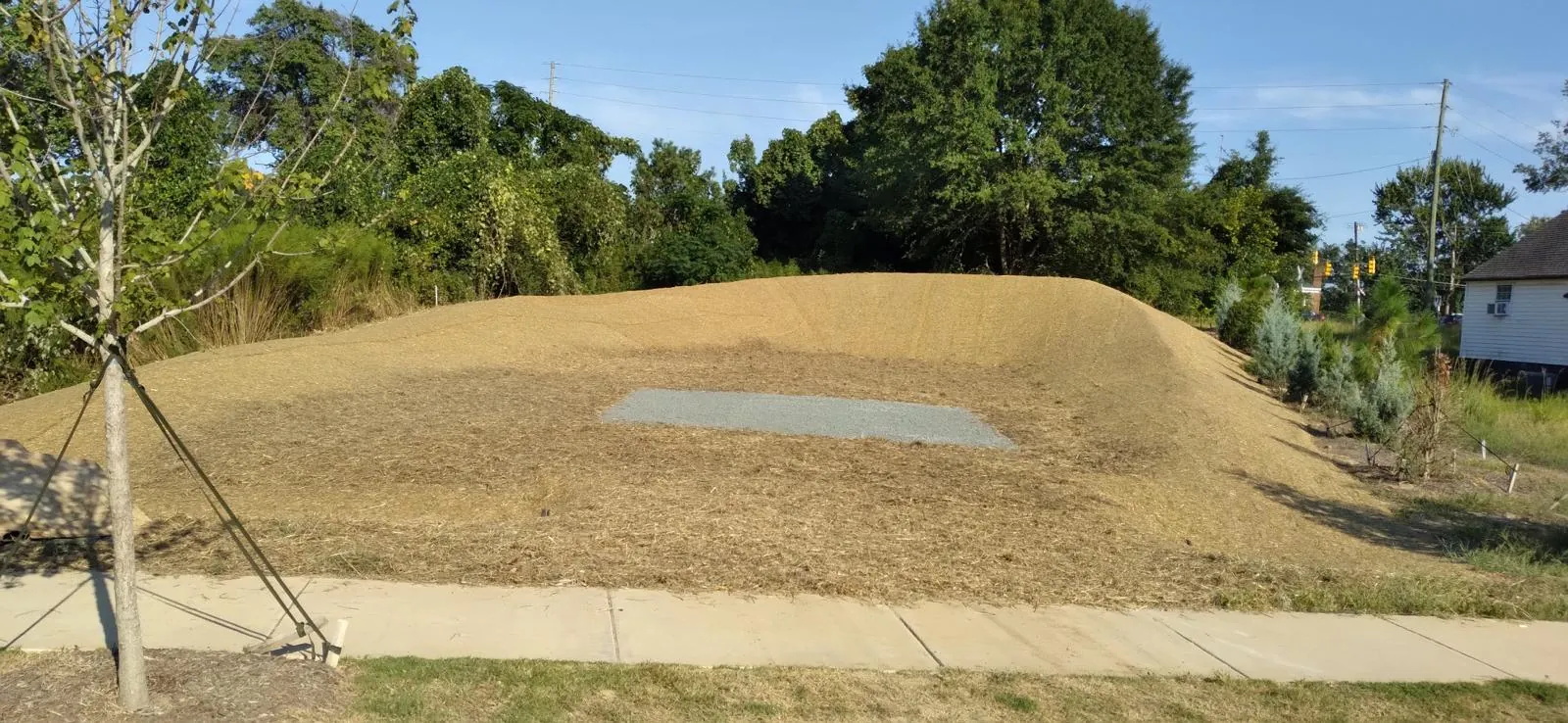 Finished stone pad and stabilized berm at Midtown Rows