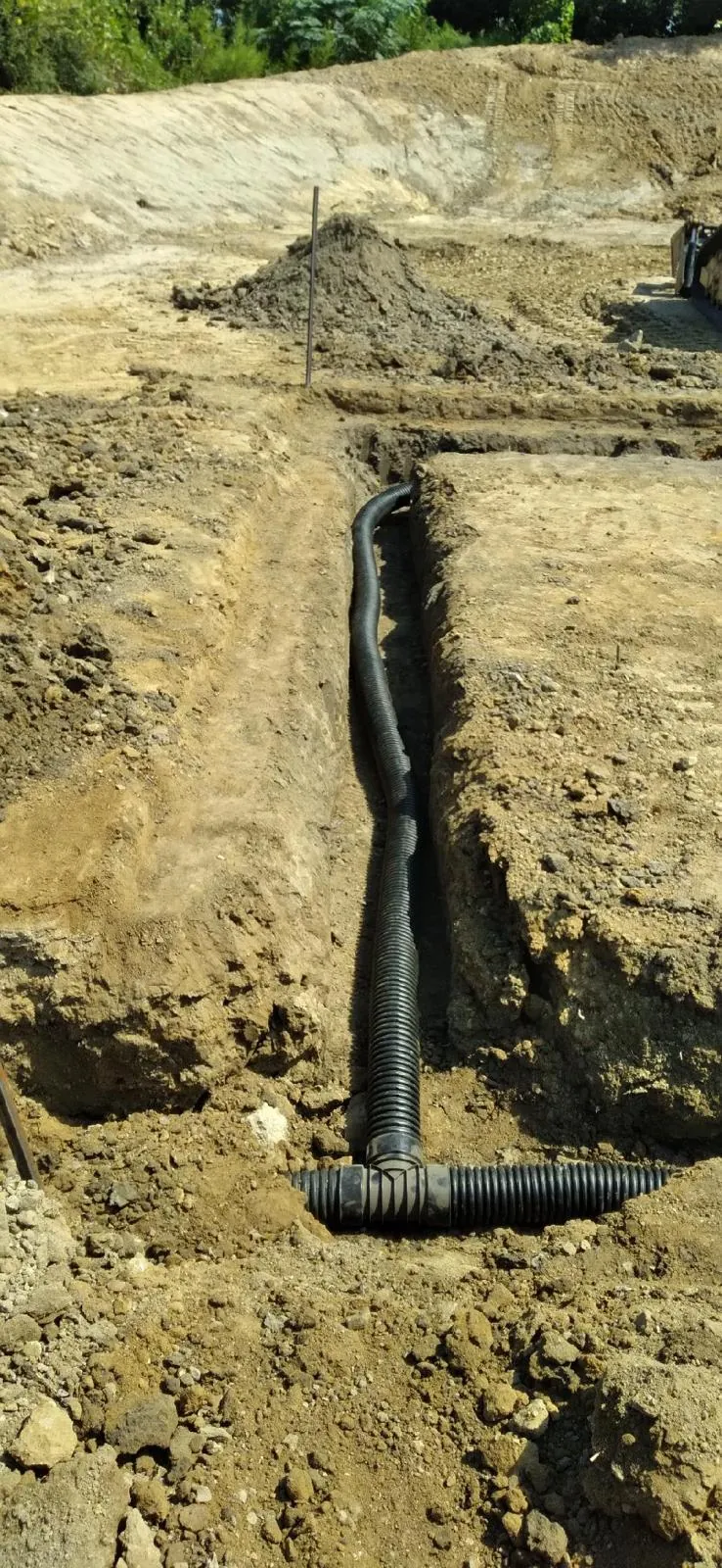 Drainage system beneath a graded berm at Midtown Rows