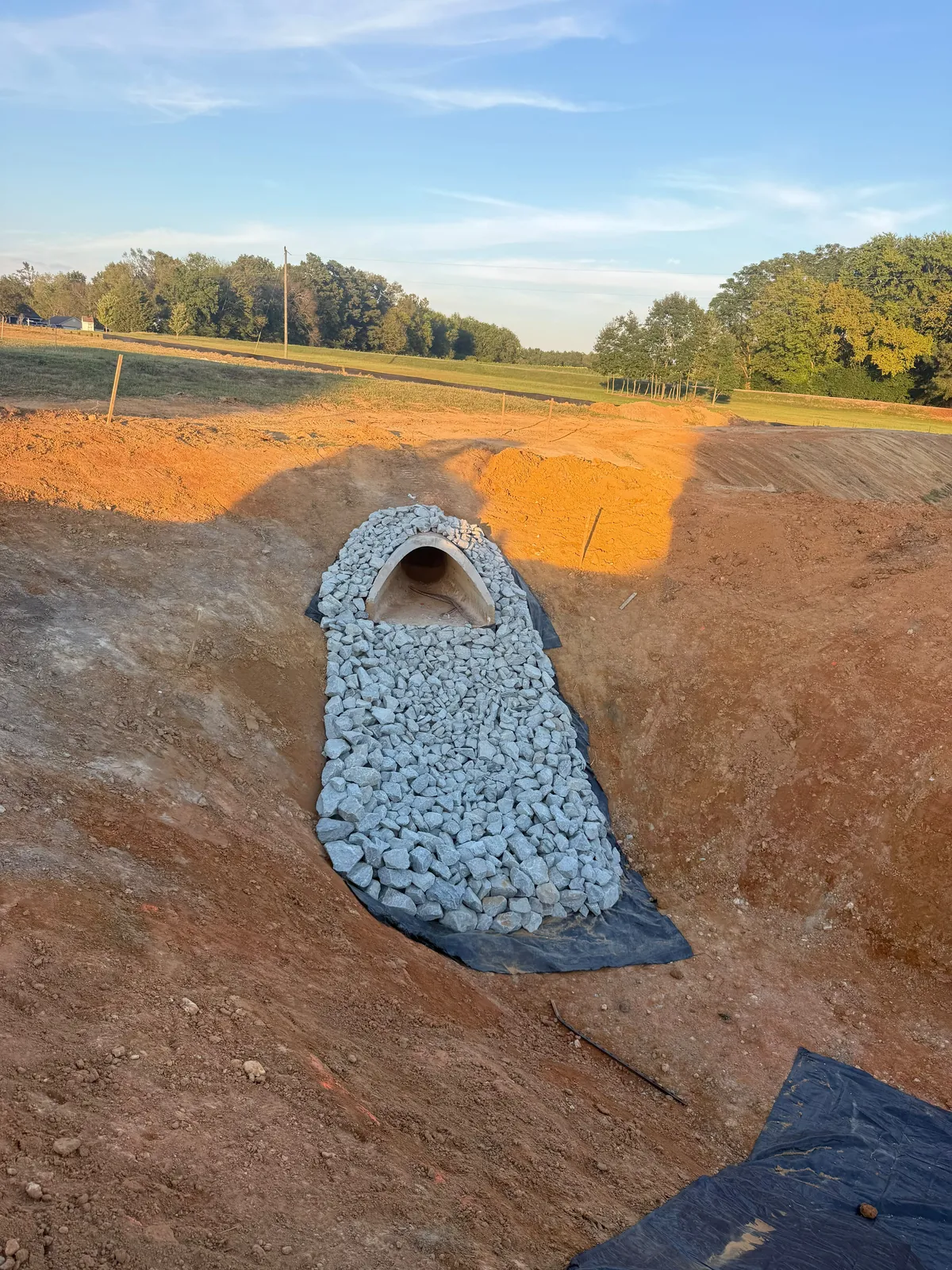 Outlet pipe set in rip-rap during pond conversion at Nathans Ridge Pond 1