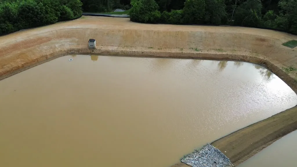 Aerial view of the excavated pond basin before grading and stabilization