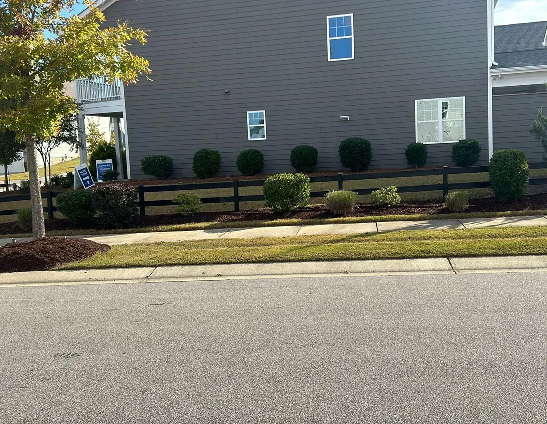 Freshly installed landscaping beds and sod at a North Carolina home entrance